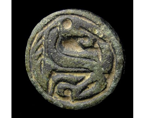 Anglo-Saxon 'Beast looking backwards' mount. A circular mount with a single fixing point on the reverse. The face of the piec