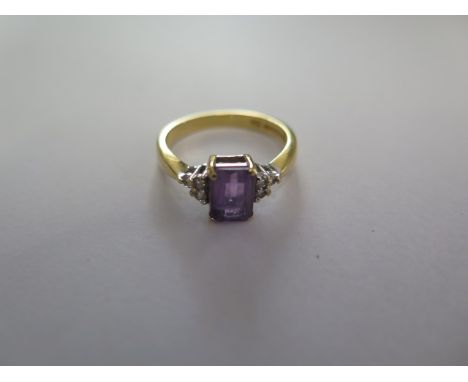 A hallmarked 18ct yellow gold amethyst and diamond ring size N - approx weight 3.6 grams - in good condition 