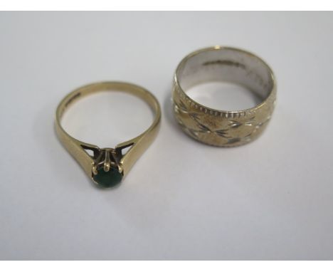 A 9ct white gold band ring size M/N and a 9ct green stone ring (stone worn) ring size O/P - total weight approx 8.5 grams 