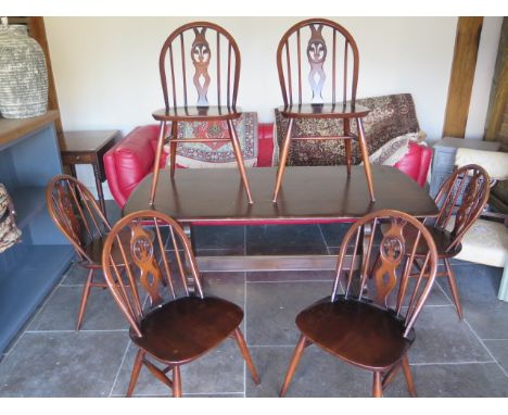 A vintage Ercol dining table and six matching chairs - 150cm x 75cm 