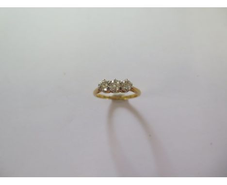 An 18ct yellow gold three stone diamond ring size M - the central diamond approx 0.25ct - approx weight 2.9 grams - diamonds 