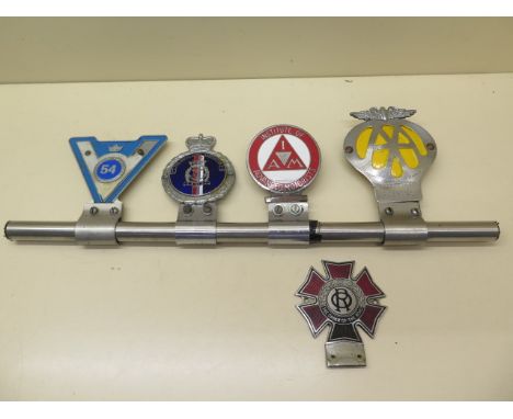 A vintage car badge bar with AA badge, Institute of Advanced Motorists, The Royal Naval Association and GEM 54 badges, also a