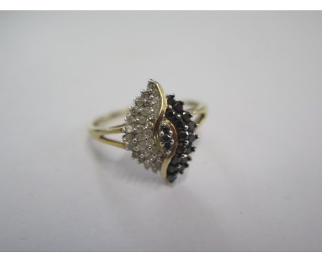 A 9ct yellow gold black and white diamond ring - head size approx 17mm x 12mm - ring size T - in good condition 