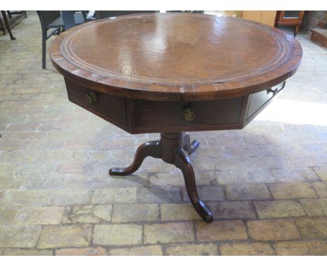 An oak circular drum table with leather inset top over a hexagonal frieze with three active drawers on a tripod base - 93cm d