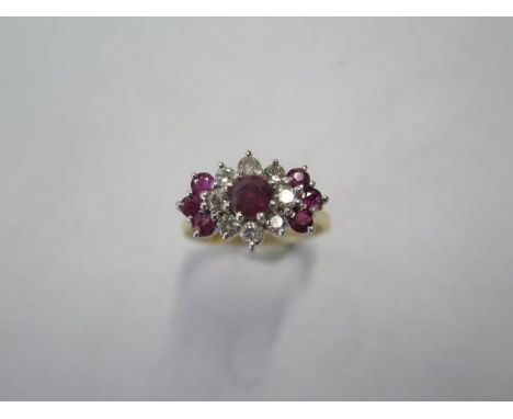 A yellow gold diamond and ruby type cluster ring - surface tests to approx 18ct - with a central stone surrounded by 8 diamon