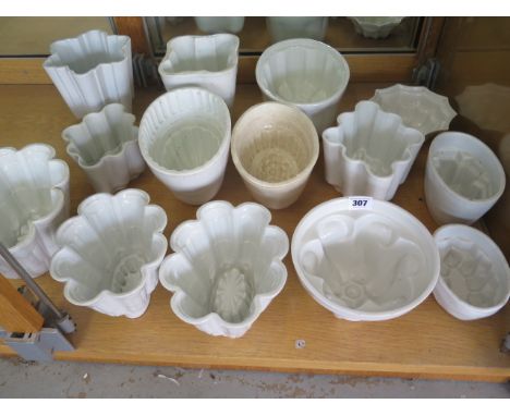 A collection of 14 white ceramic jelly moulds including two Shelley moulds - all generally good, some crazing and staining ma
