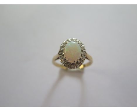 A 9ct yellow gold opal and diamond ring size M - approx weight 2.5 grams - head approx 13mm x 10mm - in good condition 