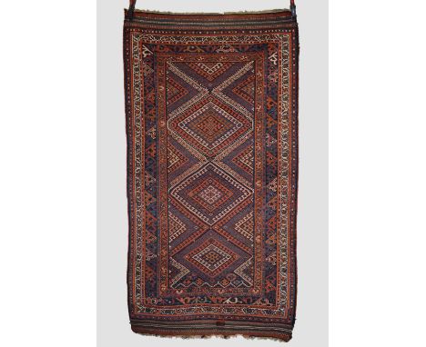 Kurdish rug, north west Persia, circa 1930s 6ft. 11in. X 3ft. 9in. 2.11m. X 1.14m. Overall even wear with corrosion to dark b