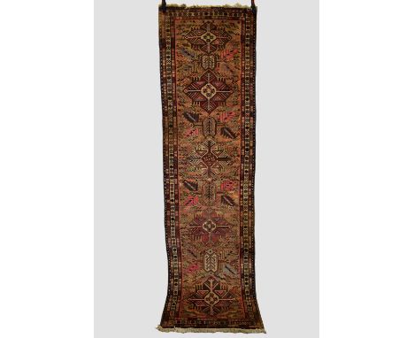 Sarab runner, north west Persia, mid-20th century, 9ft. 8in. X 2ft. 8in. 2.94m. X 0.81m. Surface marks in places. Camel field