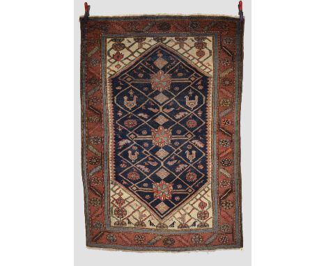 Kurdish rug, north west Persia,  early 20th century, 6ft. 5in. X 4ft. 5in. 1.96m. X 1.35m. Overall wear. Dark blue diamond sh