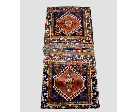 Qashqa'i double khorjin, Fars, south west Persia, circa 1900, 3ft. 9in. X 1ft. 8in. 1.14m. X 0.51m.  Dark blue faces with lar