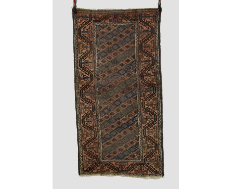 Two Baluchi rugs, Khorasan, north east Persia, the first a long rug of lattice design, early 20th century, 6ft. 5in. X 3ft. 5