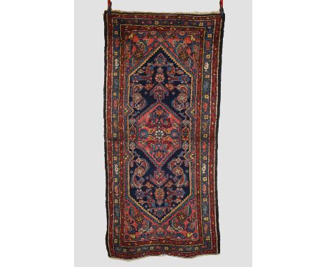 Hamadan rug, north west Persia, circa 1930s-40s, 7ft. 8in. X 3ft. 7in. 2.34m. X 1.09m. 'Bite' to outer guard lower end. Dark 