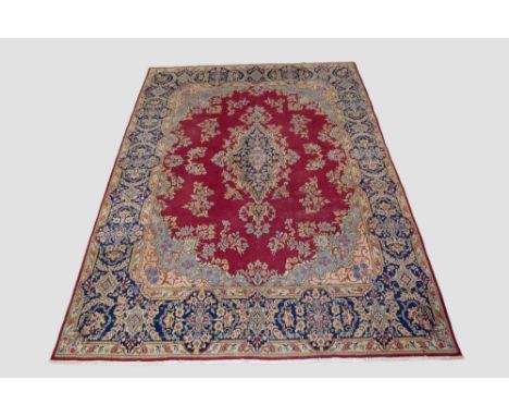 Kerman carpet, south east Persia, circa 1950s, 14ft. X 9ft. 10in. 4.27m. X 3m. Some wear in places. Pinky-red cartouche-shape