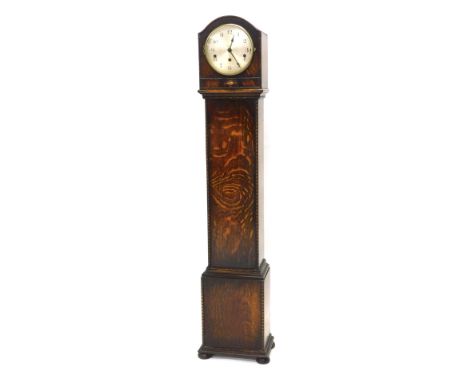 A 1920s oak grandmother clock, the silvered dial with Arabic numbers, 129cm high.