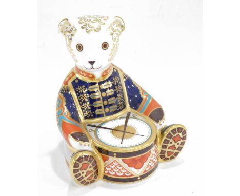 A Royal Crown Derby porcelain Drummer Bear paperweight, red printed mark to underside and gold button, 10cm high.  (boxed)