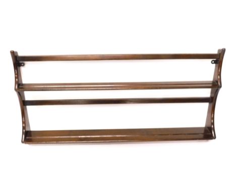 An Ercol elm two tier wall shelf, with shaped supports, 50cm high, 98cm wide.