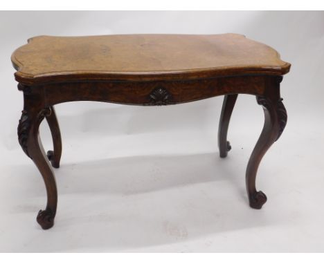 A large Victorian figured and burr walnut card table, the shaped top with a moulded edge enclosing a baize lined interior abo