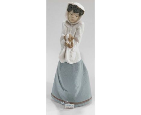 A Nao by Lladro figure, of a girl in flowing robes holding puppy, marked beneath, 35cm high. (boxed)