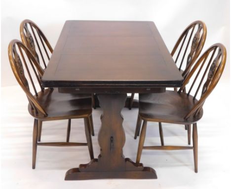 An Ercol dark oak draw leaf dining table, the rectangular top on shaped end supports, 74cm high, 114cm wide when closed, and 