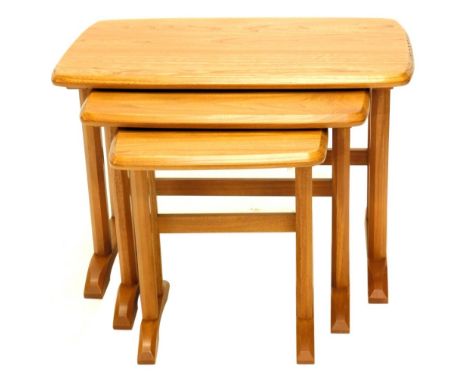 A nest of three Ercol elm tables, each with faceted legs, the largest 61cm wide.