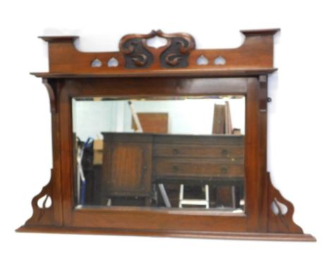 A late 19thC walnut overmantel mirror in Art Nouveau style, with a carved and pierced crest, and a shelf above a bevelled gla