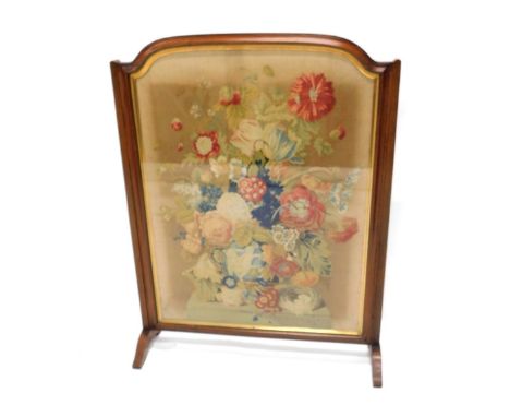 A Victorian walnut firescreen, inset with a woolwork banner of flowers, urn, etc seated on top of a pedestal, 102cm high, 81c