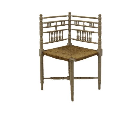 A bobbin-turned corner chair with rush seat74cm. high.