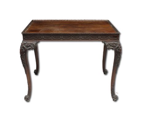 A George III carved mahogany silver tablethe rectangular top with fretwork above a carved frieze on four foliate carved legs 