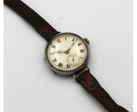 A silver cased trench watchthe round enamel dial with Roman numerals, subsidiary dial, brown leather strap.