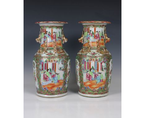 A pair of Chinese famille rose vaseshaving applied gilt lizards, and twin creature handles, reserves of figures in exterior &