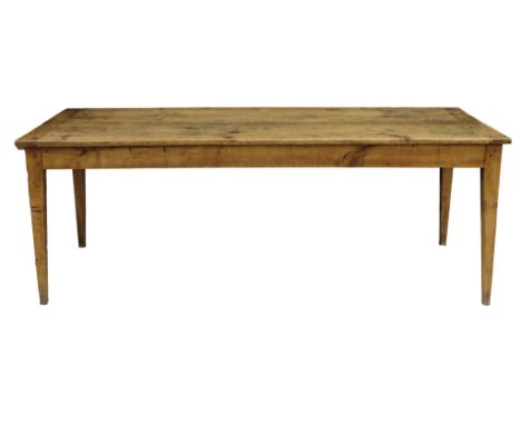 A French cherry wood farmhouse table the plank top with cleated ends over a plain frieze with single end drawer on square tap