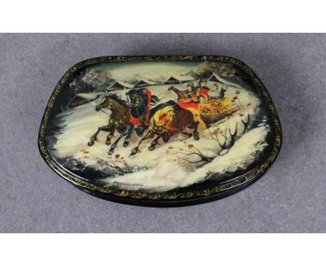 A mid to late 20th century Russian lacquered boxof satchel form, the hinged cover depicting a snowy scene with horses pulling