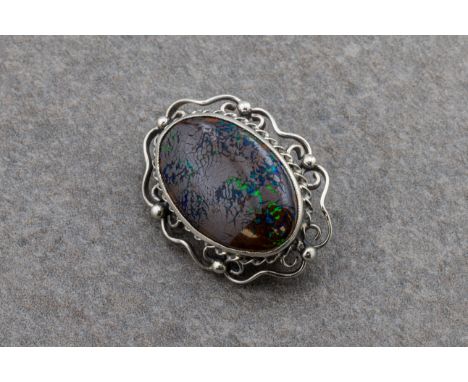 A silver and matrix opal oval broochthe oval cabochon opal approximately 22.7mm x 14.9mm x 4.4mm, total gross weight approxim