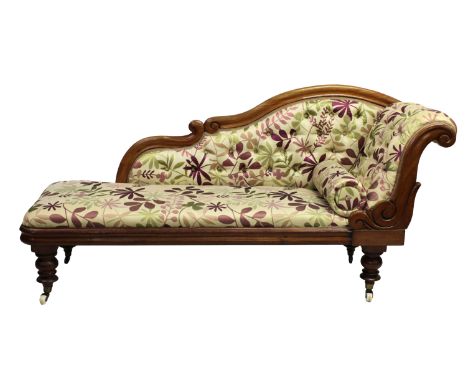 A Victorian mahogany chaise longue scroll detail, button back silk floral fabric, turned supports, ceramic and brass casters,
