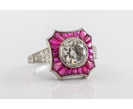 An Art Deco style platinum, diamond and ruby dress ringthe central old cut diamond approximately 1.31ct, within a shaped bord