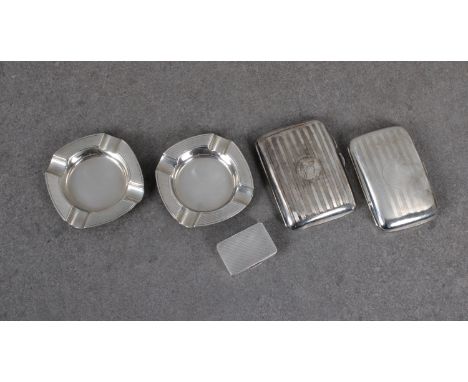 A collection of smoking related silver collectables - To include two silver cigarette casestogether with a pair of silver ash
