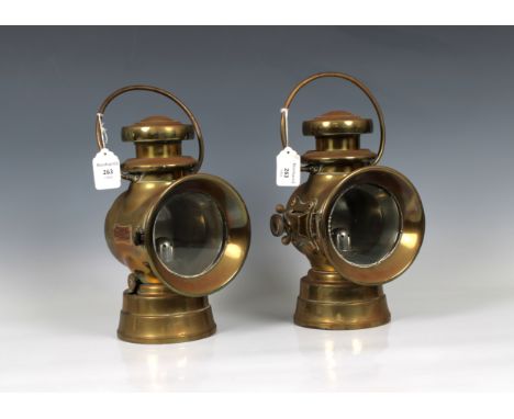 A pair of early 20th century Lucas brass oil automobile lightsclear glass to the front, red glass to the back, copper plates 