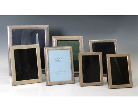 A collection of various silver mounted easel back photograph framesvarious maker's and dates, the largest 31 x 26cm. (7)