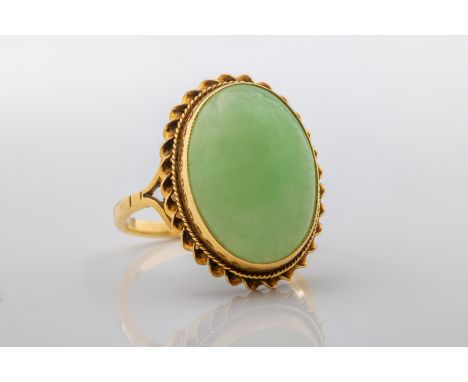 A 9ct yellow gold and jade dress ringthe oval cabochon jade approximately 17mm x 12mm x 5.2mm, ring size N1/2, total gross we