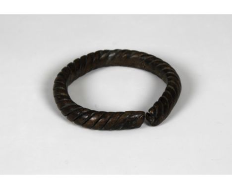700-1100 AD, Viking Age. A heavy bronze twisted braceletcomprising several strands of bronze woven together, clubbed ends.