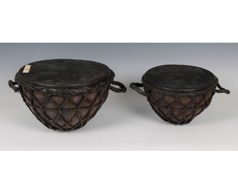 Two Rajastani table drumsformed of animal skin stretched across a metal frame, 21cm. diameter 18cm. high and 27cm. diameter 1