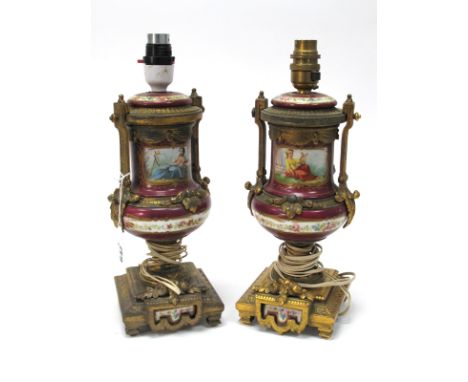 A Pair of Late XIX Century Clock Ornaments, the porcelain bodies decorated with figures representing music and painting, with