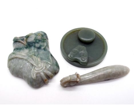 A Chinese Mottled Green Jade Belt Buckle, with circular boss and dragon head, 8.5cm long; A Circular Dark Green Jade Buckle, 