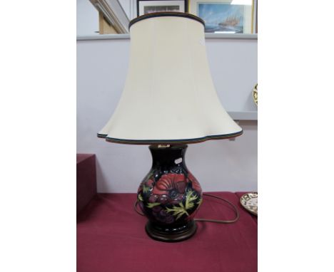 A Modern Moorcroft Pottery Table Lamp, painted in the 'Anemone' pattern with purple flowers against a dark blue ground, on a 