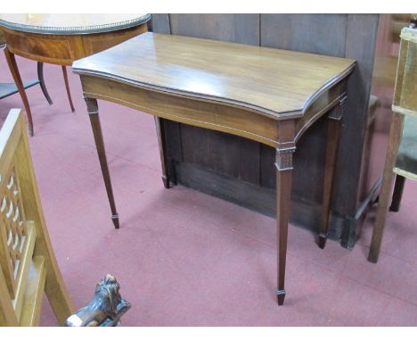 An Early XX Century Mahogany Card Table, with serpentine front and fold-over top revealing green baize interior, acanthus lea