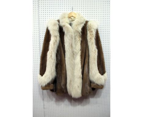 A Light Brown Mink Jacket, retailed by Glyn &amp; Leinhardt, Manchester, the sleeves and front edges with off white fox fur d