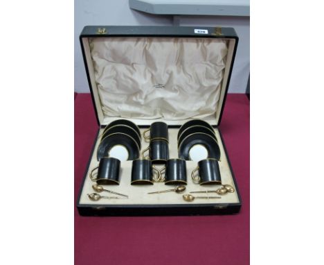An Allertons Pottery Cased Coffee Service, the exteriors decorated with black scales, the interiors in gilt, with six coffee 