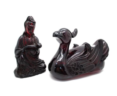 A Chinese Amber Coloured Model Carved as a Duck, in swimming posy, 17cm long; A Similar Model of Guanyin, 15.5cm high. (2)