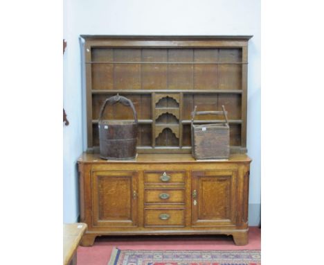 An XVIII Century Oak Dresser, the rack with stepped cornice and three shelves with reeded sides, the base with three central 